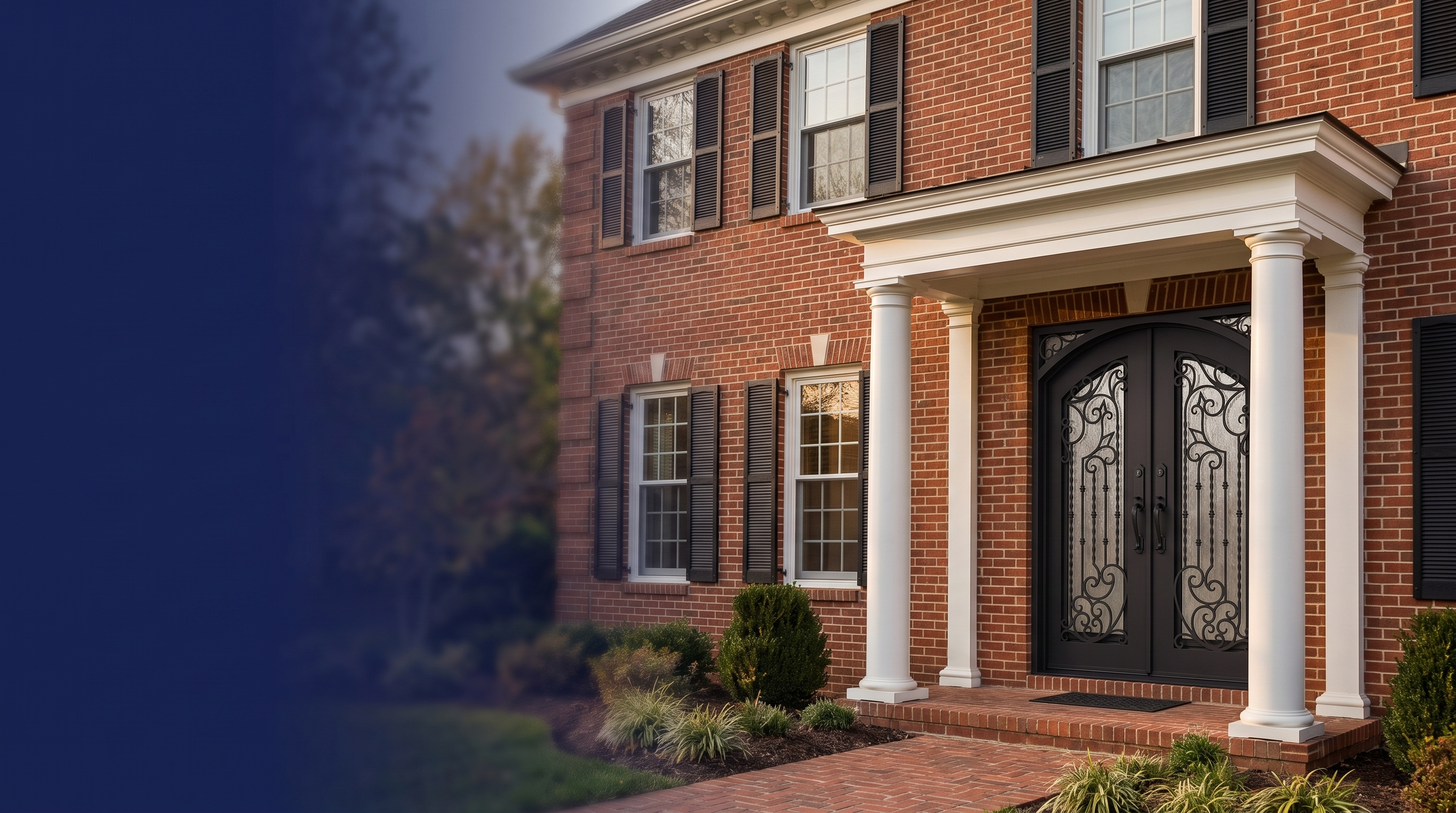 Charles wrought-iron double entry door on a classic red-brick colonial home