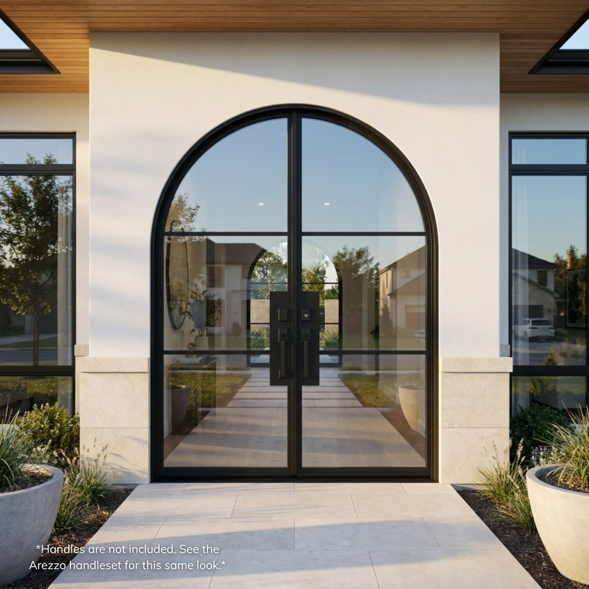 3-lite French steel entry double door, arch top design, matte black finish with full-view glass panels, installed on a modern stucco home exterior