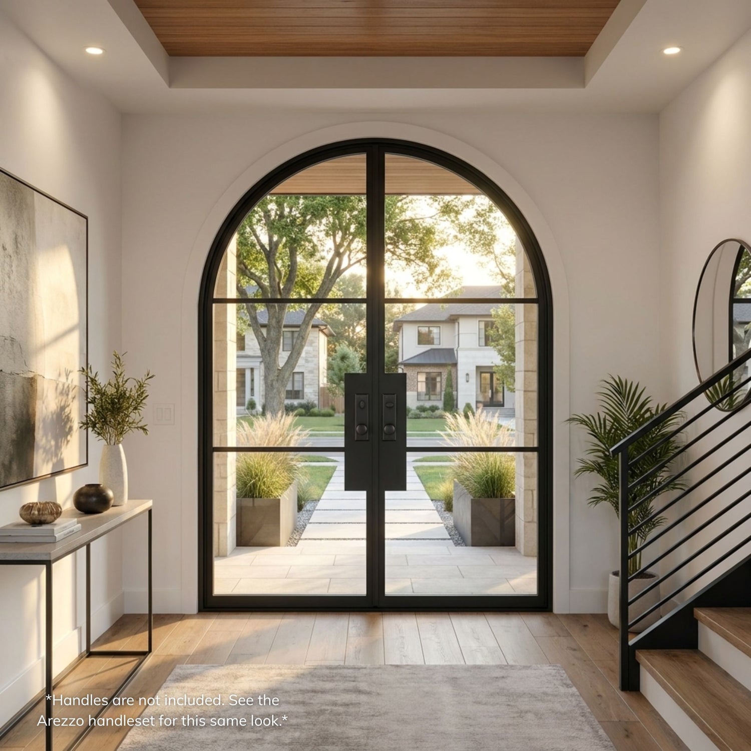 3-lite French steel entry double door, arch top design, matte black finish with full-view glass panels, viewed from the interior of a modern foyer