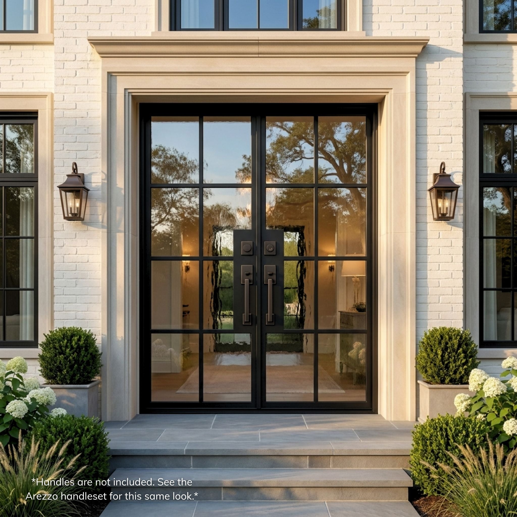 8-lite French steel double entry door with Flemish glass, matte black finish, installed on a white brick home exterior with stone surround and covered entry