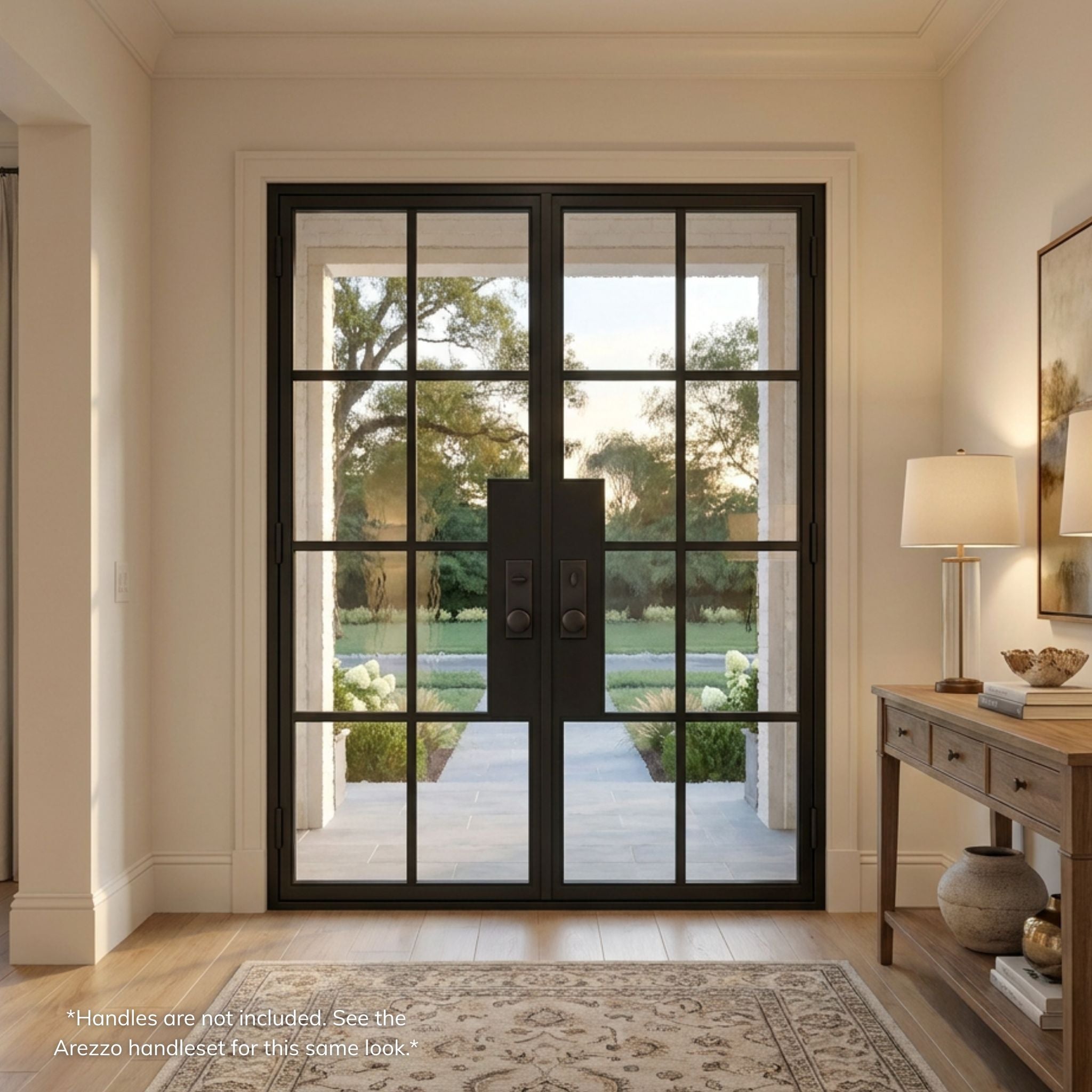 8-lite French steel double entry door with Flemish glass, matte black finish, installed in a bright transitional-style foyer with wood flooring and a console table