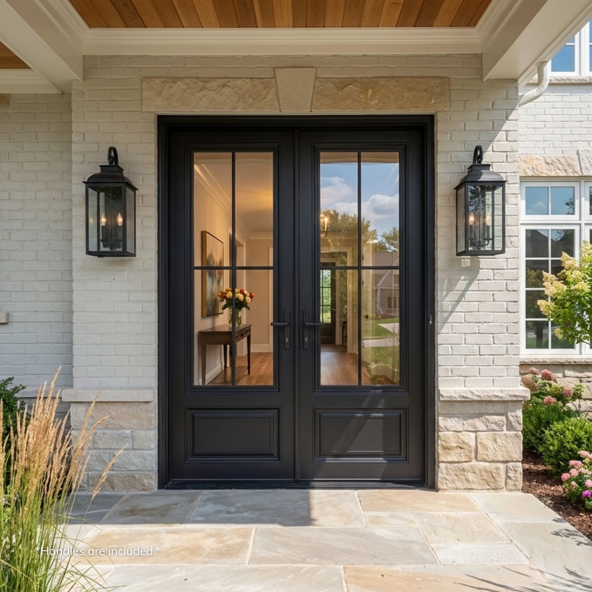 Alexus aluminum 4-lite double entry door, matte black finish with divided-lite clear glass, installed on a white brick and stone home exterior