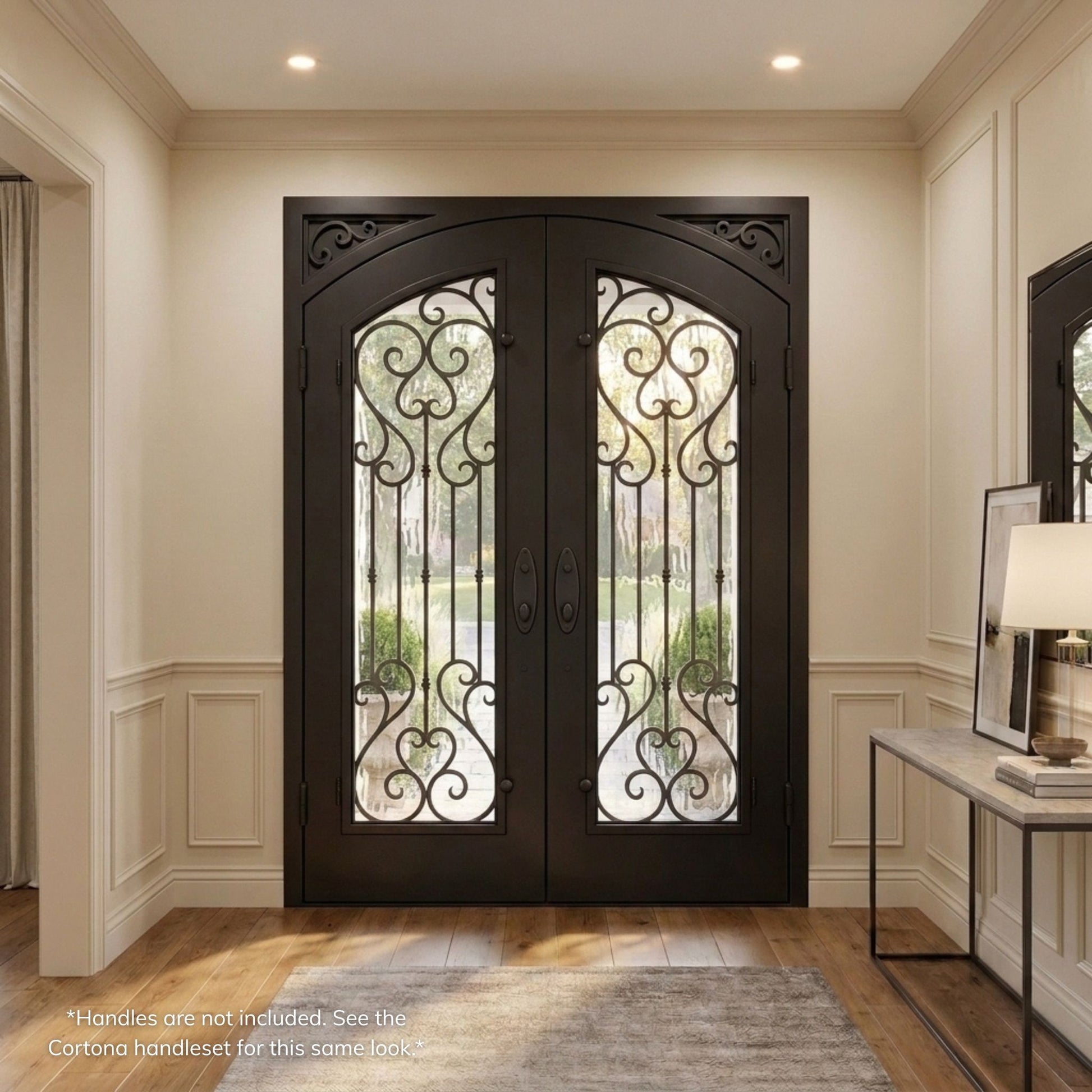 Anastasia double iron entry door, dark oil rubbed bronze finish with vertical scrollwork glass panels and scalloped corner accents, viewed from the interior view of a transitional-style foyer