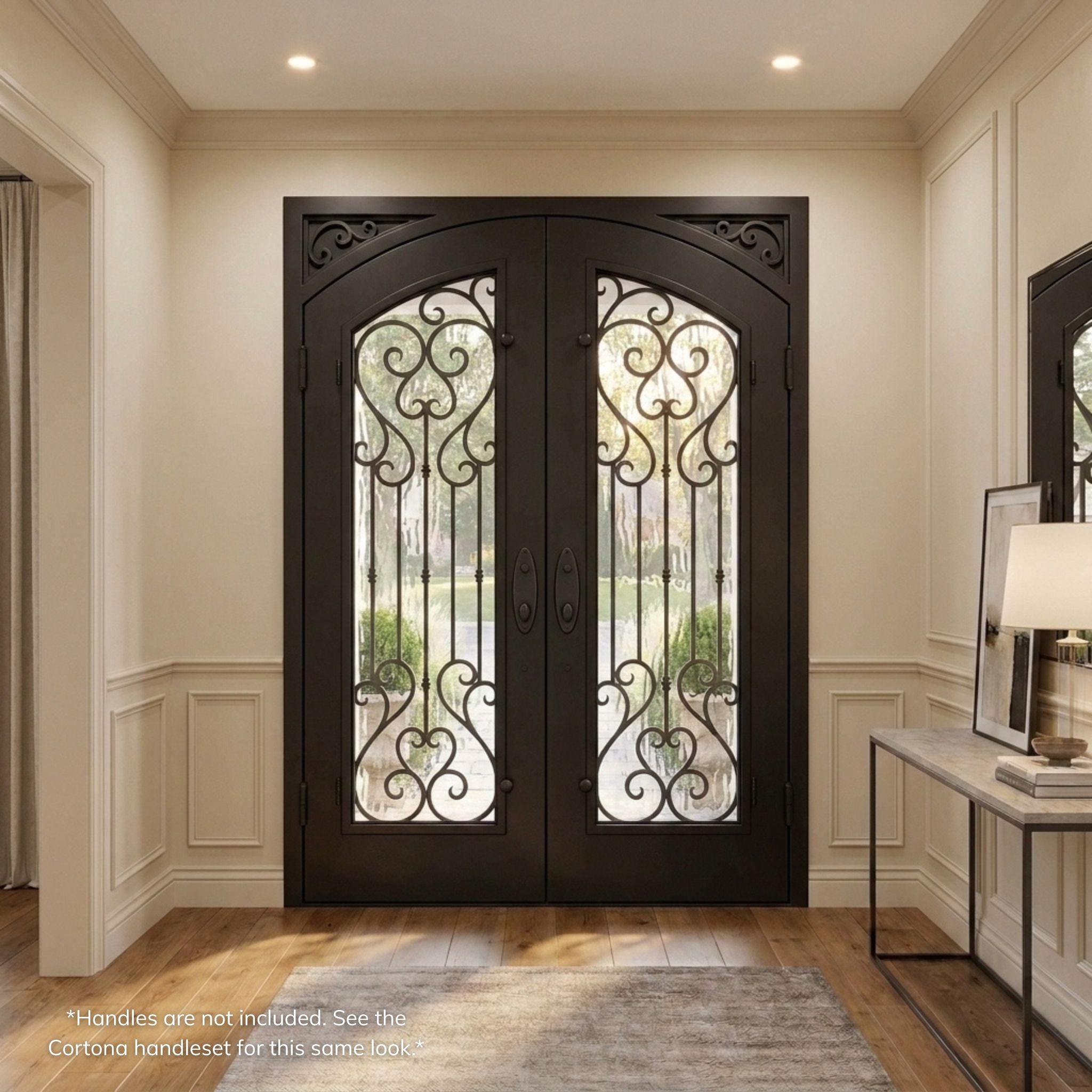 Anastasia double iron entry door, dark oil rubbed bronze finish with vertical scrollwork glass panels and scalloped corner accents, viewed from the interior view of a transitional-style foyer