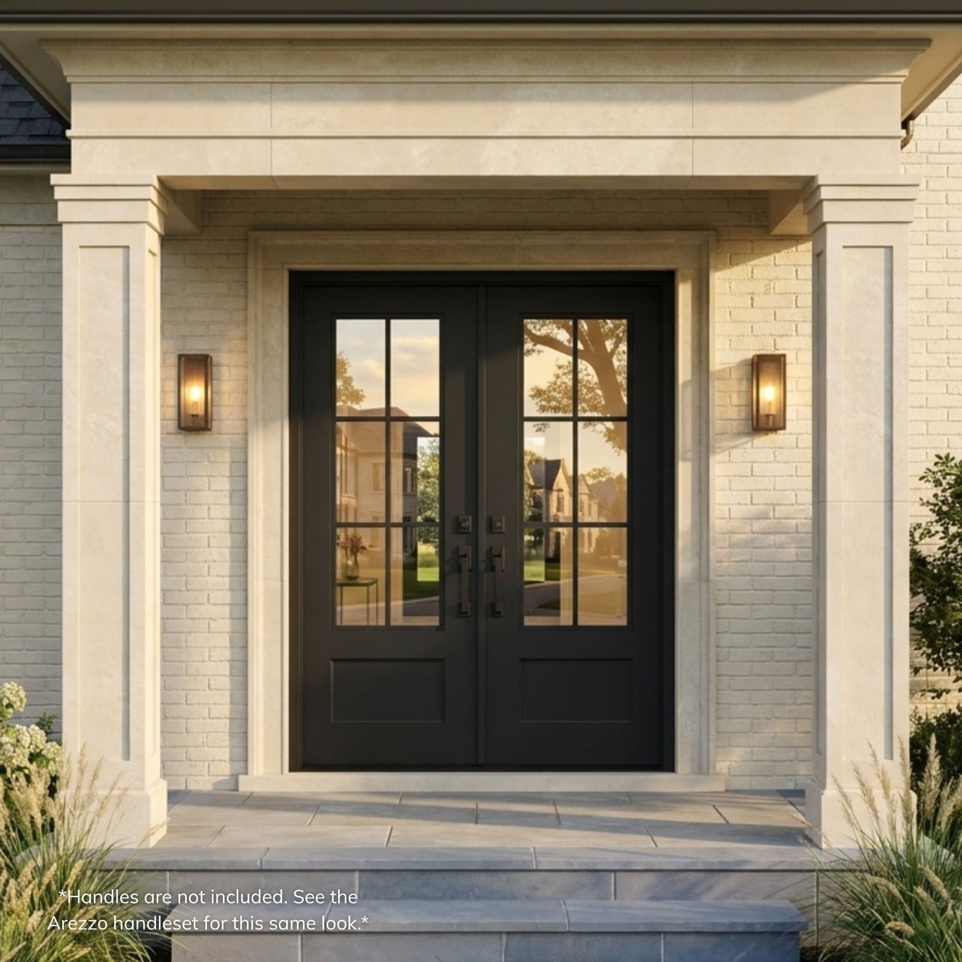 Artigiano wrought iron entry double door with 6-lite clear glass, matte black finish, operable glass, installed on a white brick home exterior with stone surround and covered entry