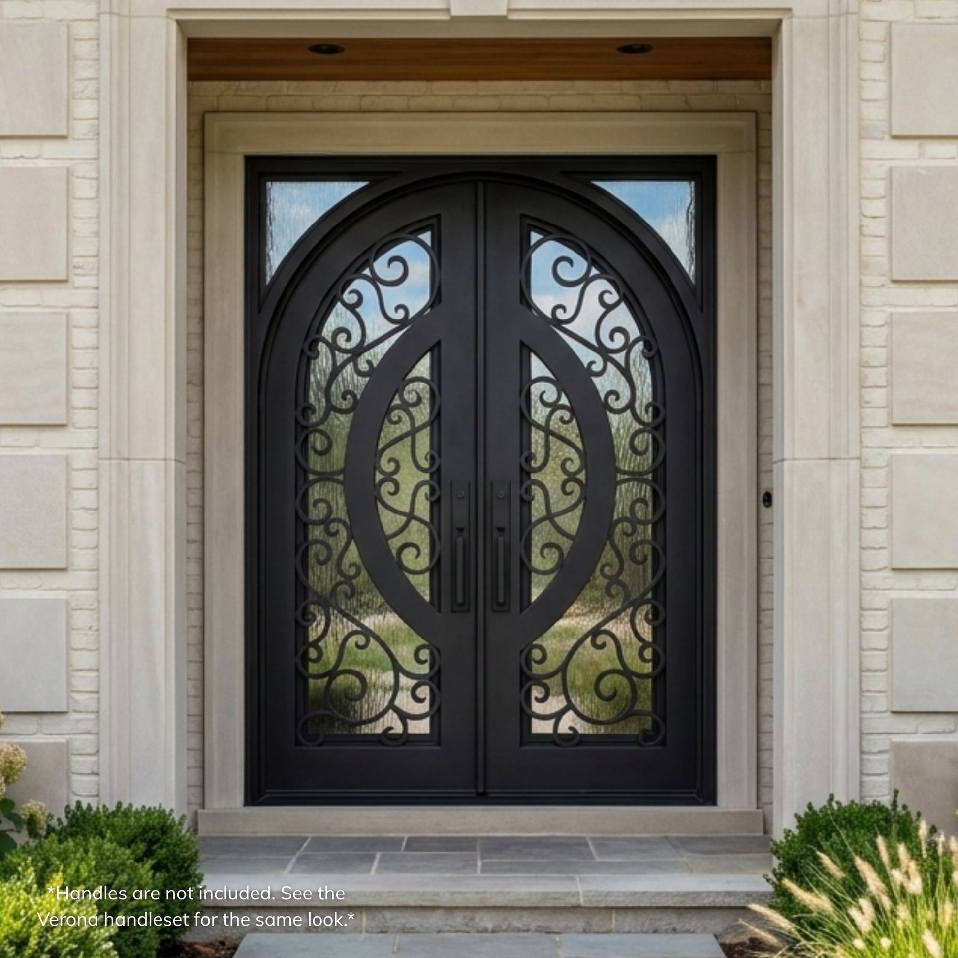 Brittany wrought iron double entry door, matte black finish with ornate curly scrollwork, flemish operable glass panels, arch-top design, installed on a stone home exterior