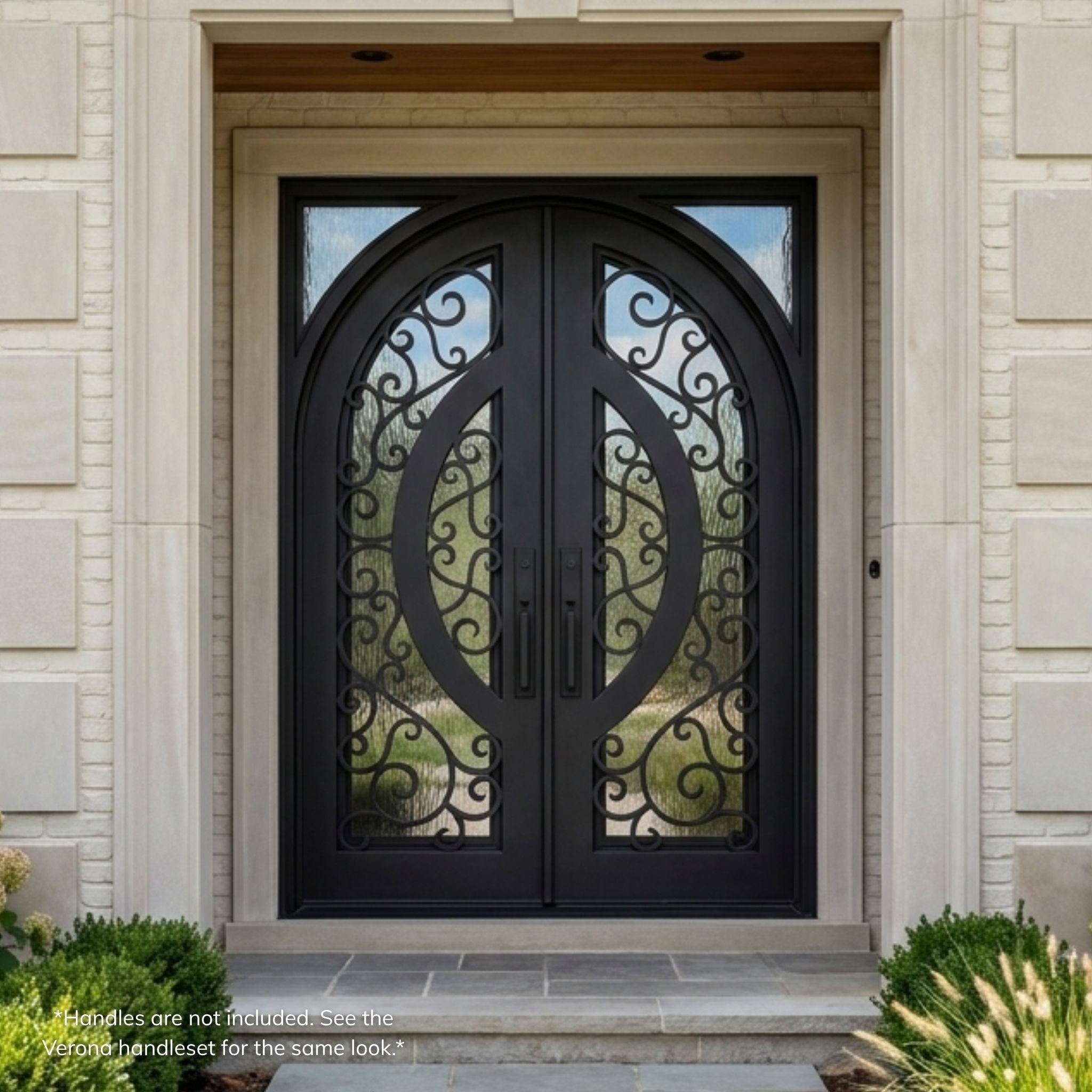 Brittany wrought iron double entry door, matte black finish with ornate curly scrollwork, flemish operable glass panels, arch-top design, installed on a stone home exterior