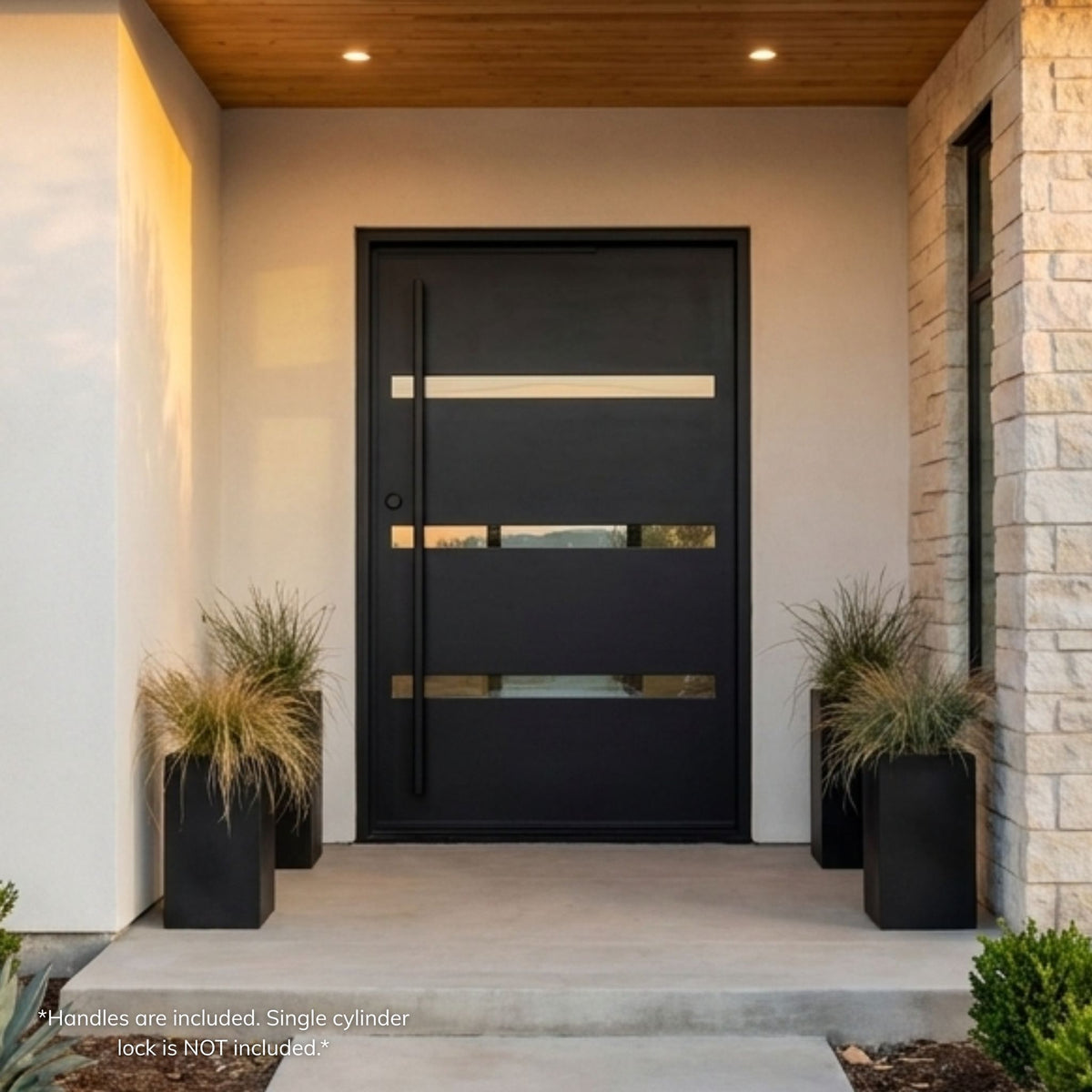 Camargo wrought iron pivot door, matte black finish with horizontal glass strip accents and vertical pull bar, installed on a modern stucco home exterior with potted grasses