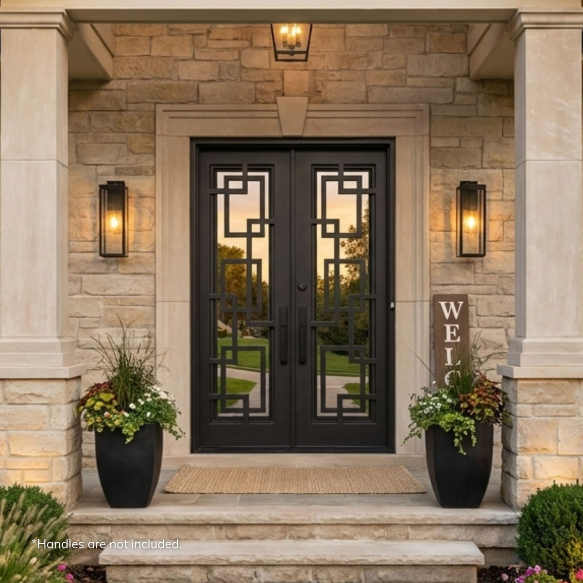 Espada dark bronze wrought iron double door with interlocking rectangular ironwork over mirror glass, installed in a stone surround on a limestone home with a covered entry