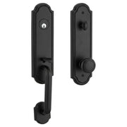 Estate handleset in matte black finish, active (keyed) function, shown from both interior and exterior sides with an arched backplate, keyed cylinder, thumb-latch grip handle, and round knob.