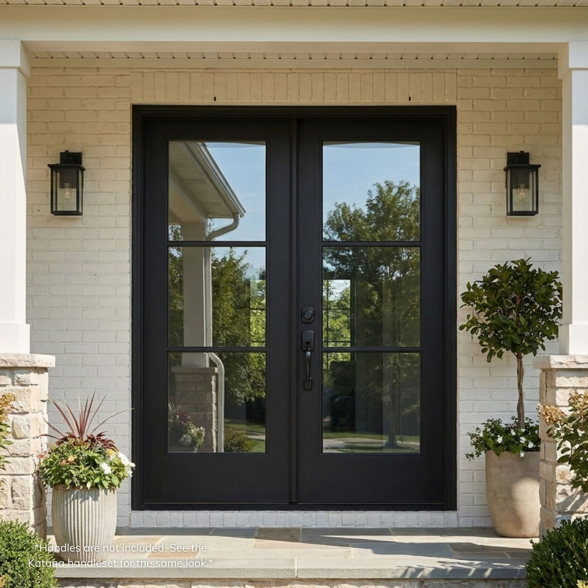 Fiberglass double entry door in a matte black finish, featuring a 3-lite clear glass grille on each leaf, installed on a brick home with matching wall lanterns.