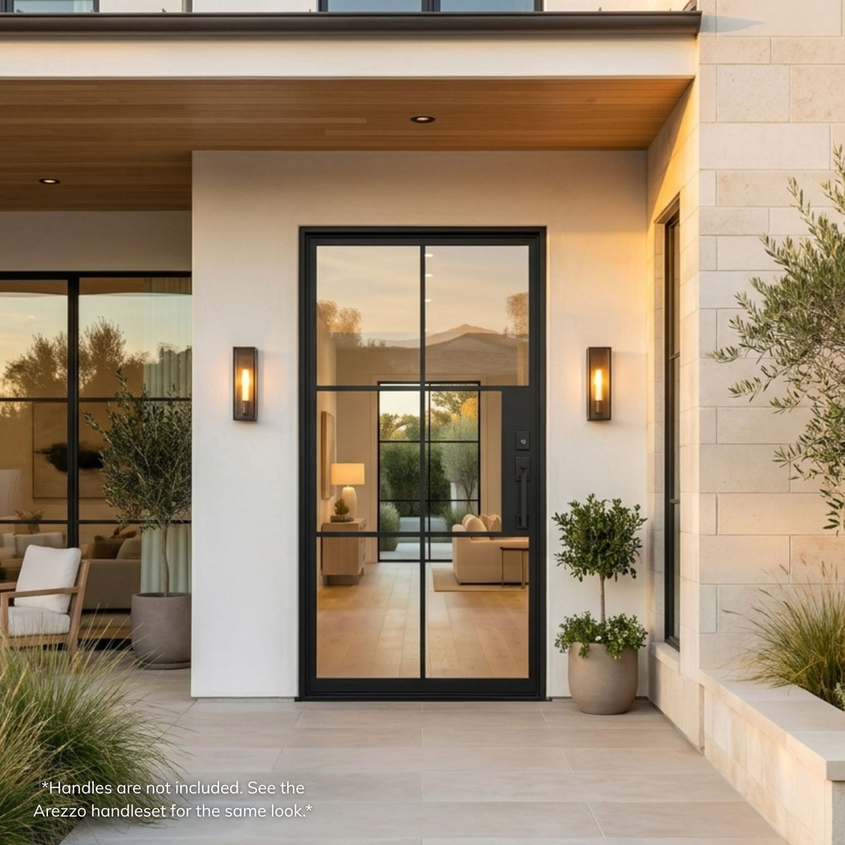 French steel 6-lite single entry door, matte black finish with full-view clear glass, installed on a modern white stucco home exterior with covered entry