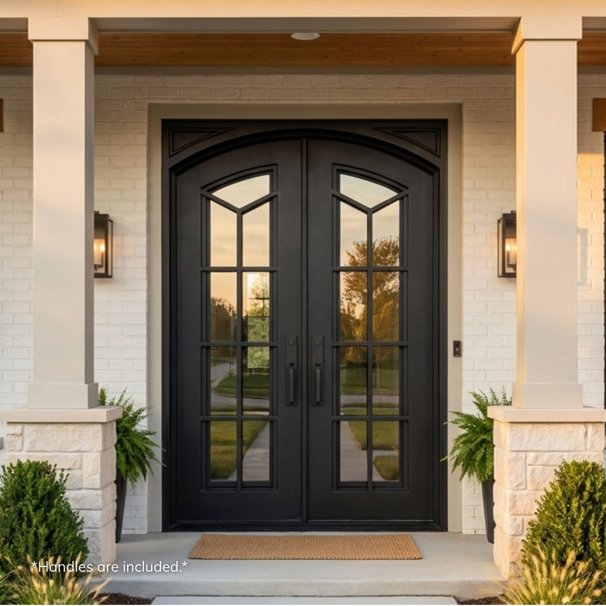Hampton wrought iron double entry door, matte black finish with 7-lite eyebrow-top clear operable glass, installed on a white brick home exterior