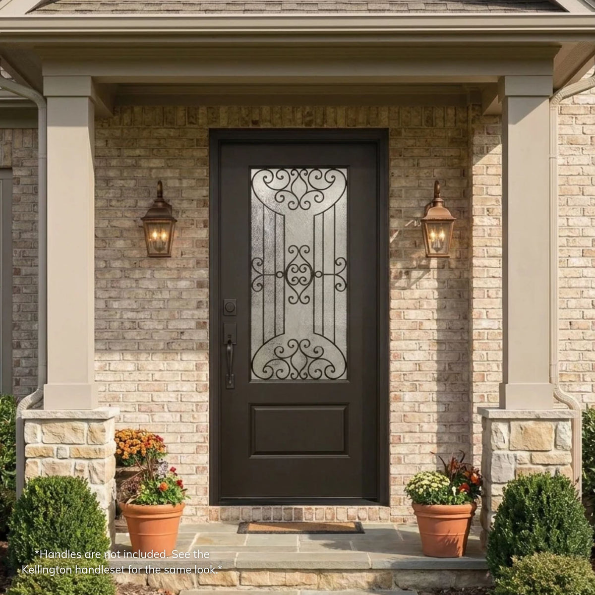 Jupiter fiberglass single entry door in dark bronze with 3/4 scrollwork glass over a raised panel, on a traditional brick home with a covered porch and stone column bases