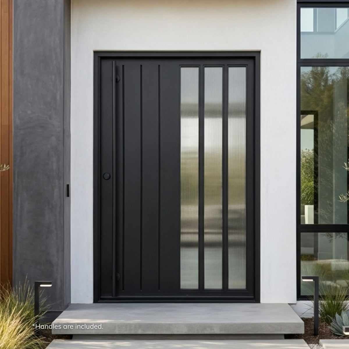 Lido wrought iron pivot entry door in matte black finish with vertical line paneling and three tall reeded frosted glass lites, installed on a white stucco modern home with a gray concrete pillar surround.