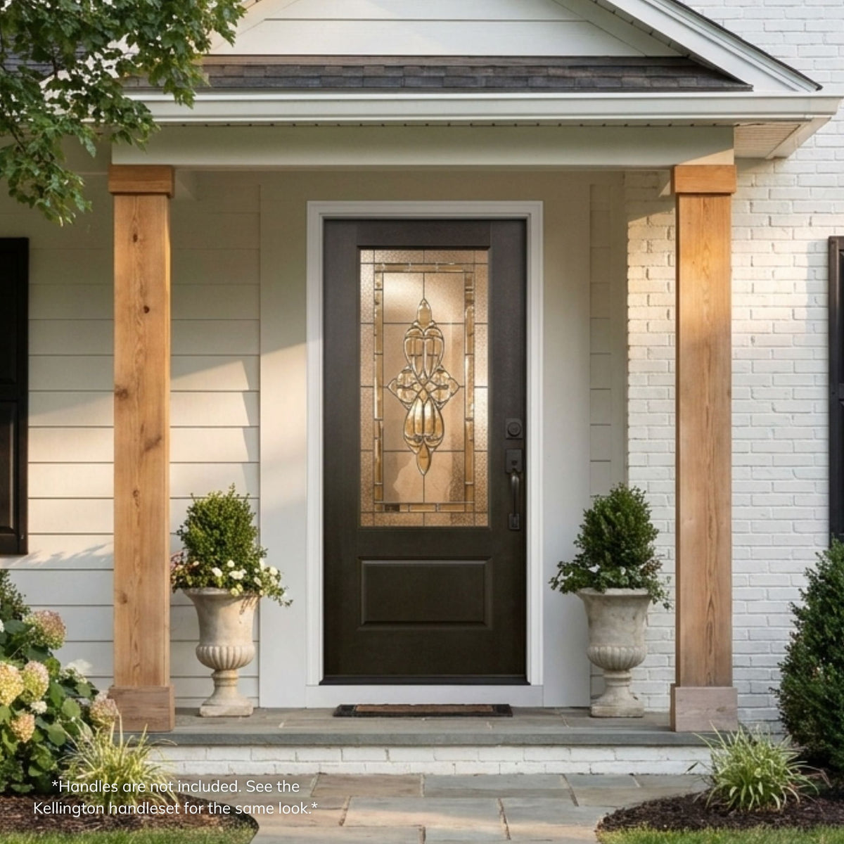 London fiberglass single entry door in a dark espresso finish with a 3/4-lite decorative glass panel featuring an ornate scroll and fleur-de-lis design, installed on a craftsman-style home.