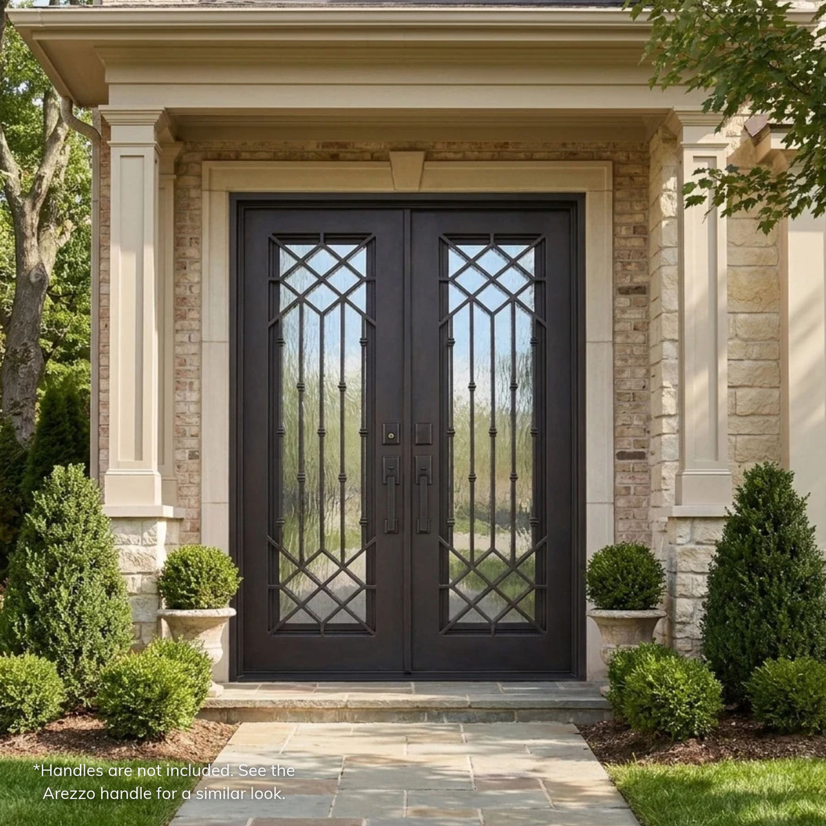 Lux full-view wrought iron double entry door in dark bronze with Flemish glass and geometric diamond and vertical bar ironwork, framed by columns on a brick and limestone traditional home
