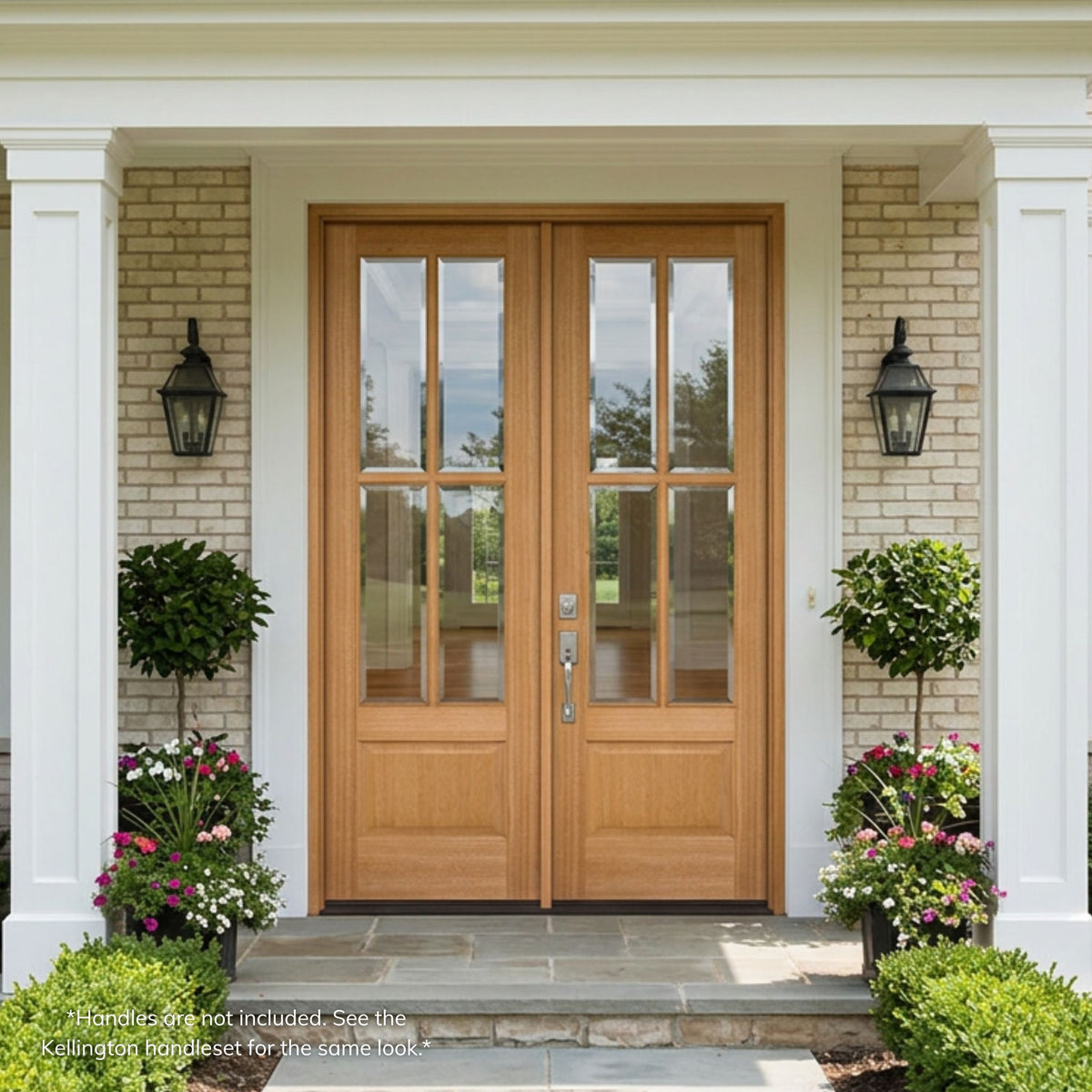 Mahogany 4-lite double entry door, wood grain, unfinished with beveled clear glass, installed on a white brick colonial-style home exterior