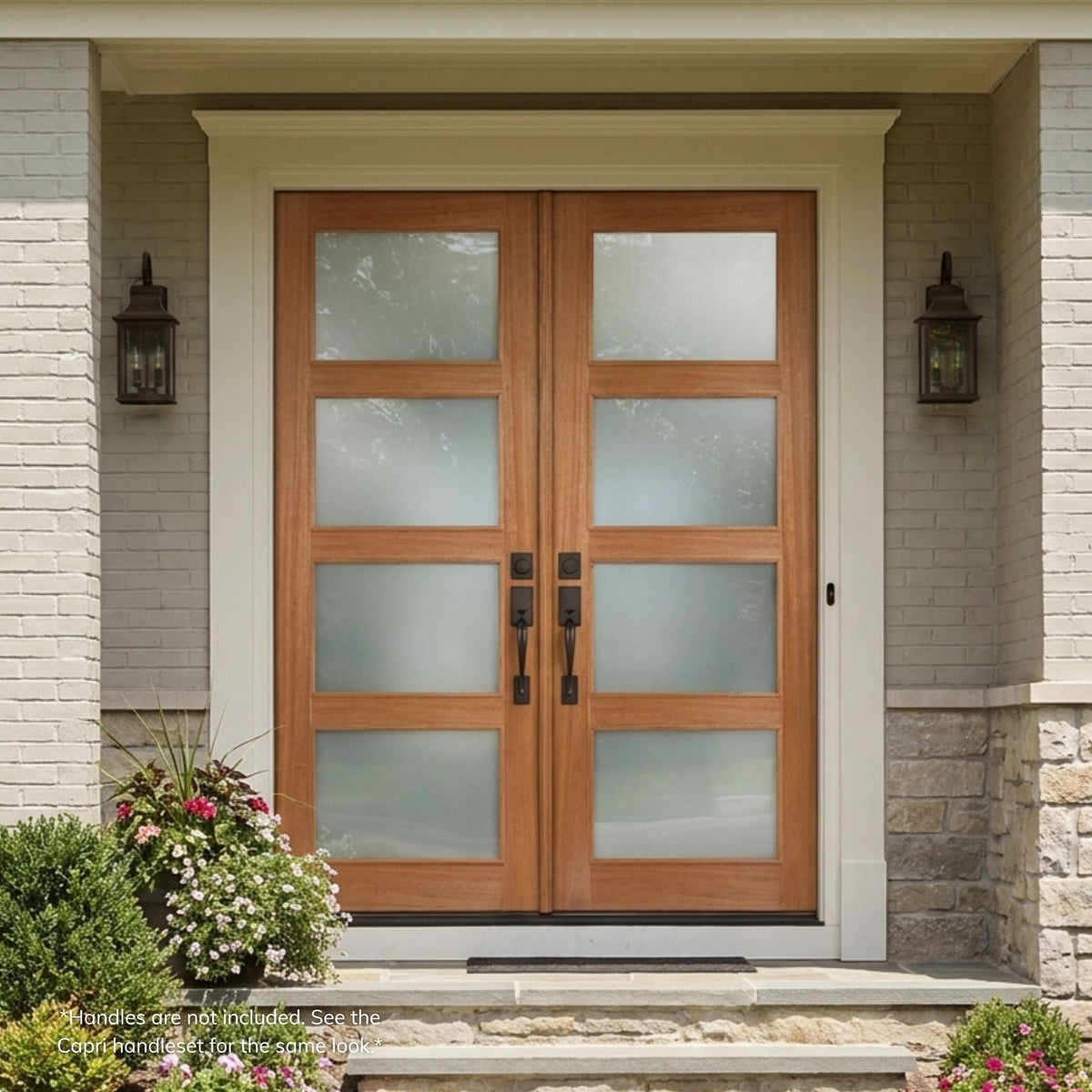 Mahogany double entry door in a natural wood finish, featuring a 4-lite vertical frosted glass grille on each leaf for privacy with natural light, installed on a brick home with matching wall lanterns.