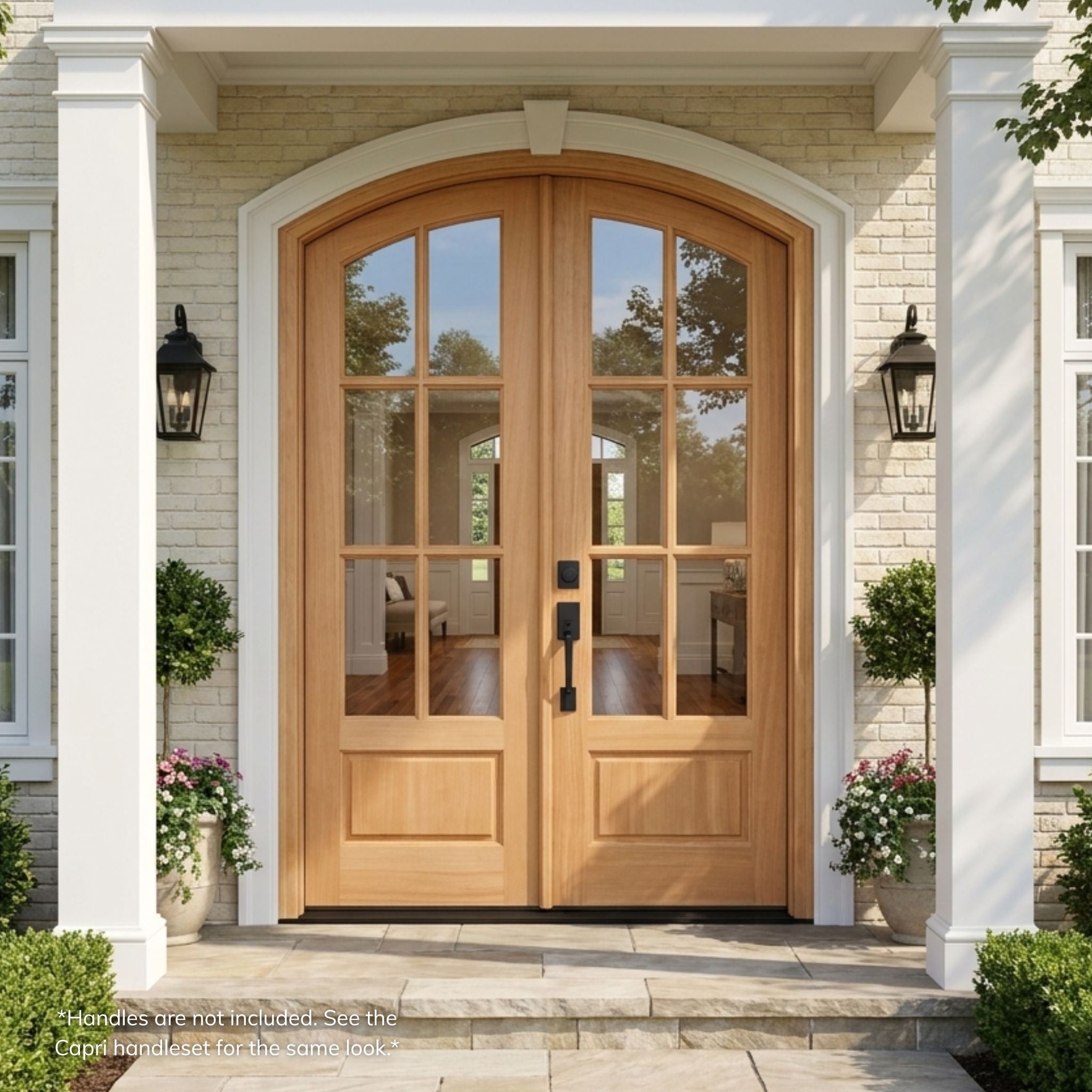 Mahogany 6-lite arch top entry door, wood grain, unfinished, with clear glass, installed on a stone home exterior