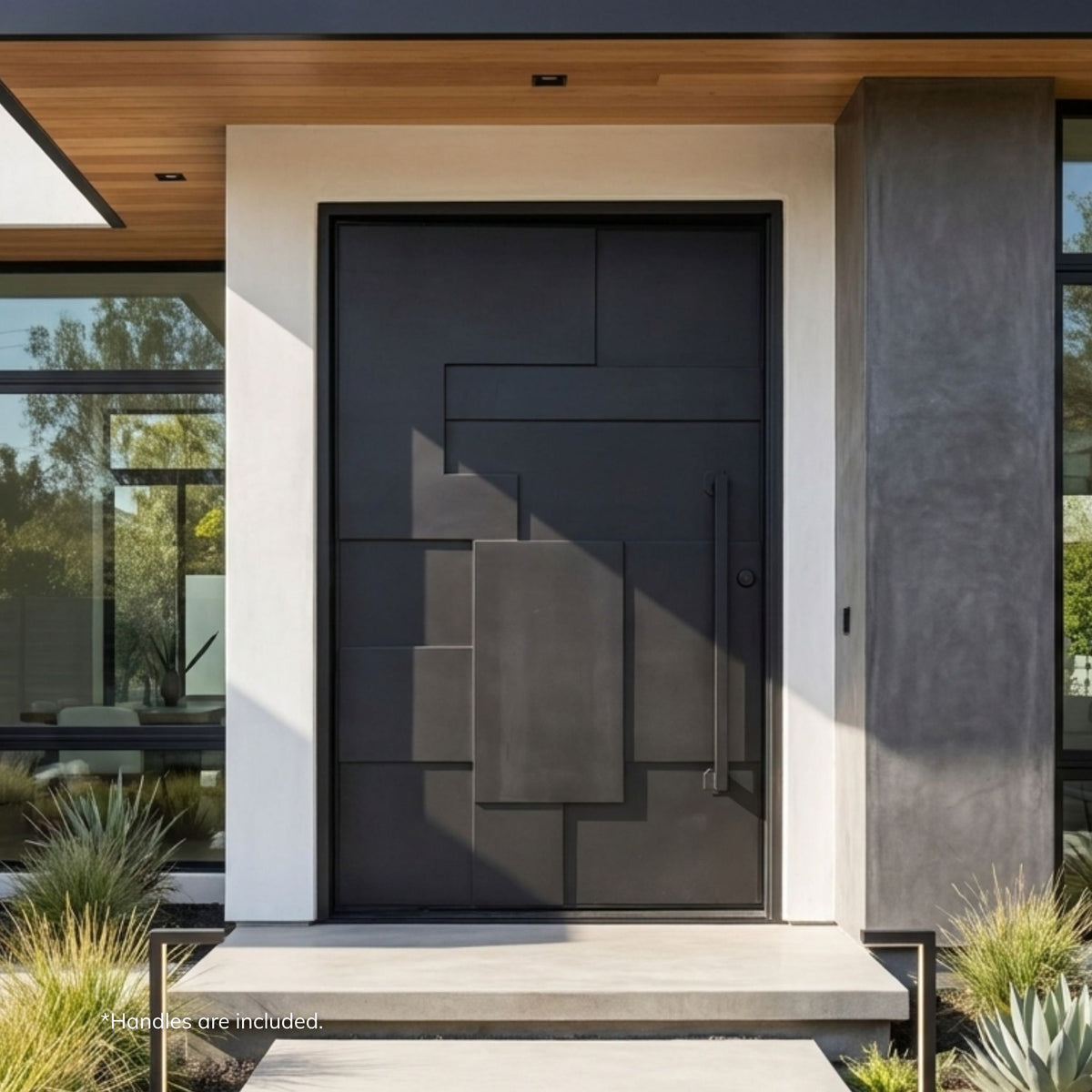 Maidstone wrought iron pivot entry door in matte black finish with an asymmetrical geometric block panel design and vertical pull handle, installed on a modern home with a wood ceiling and concrete facade.