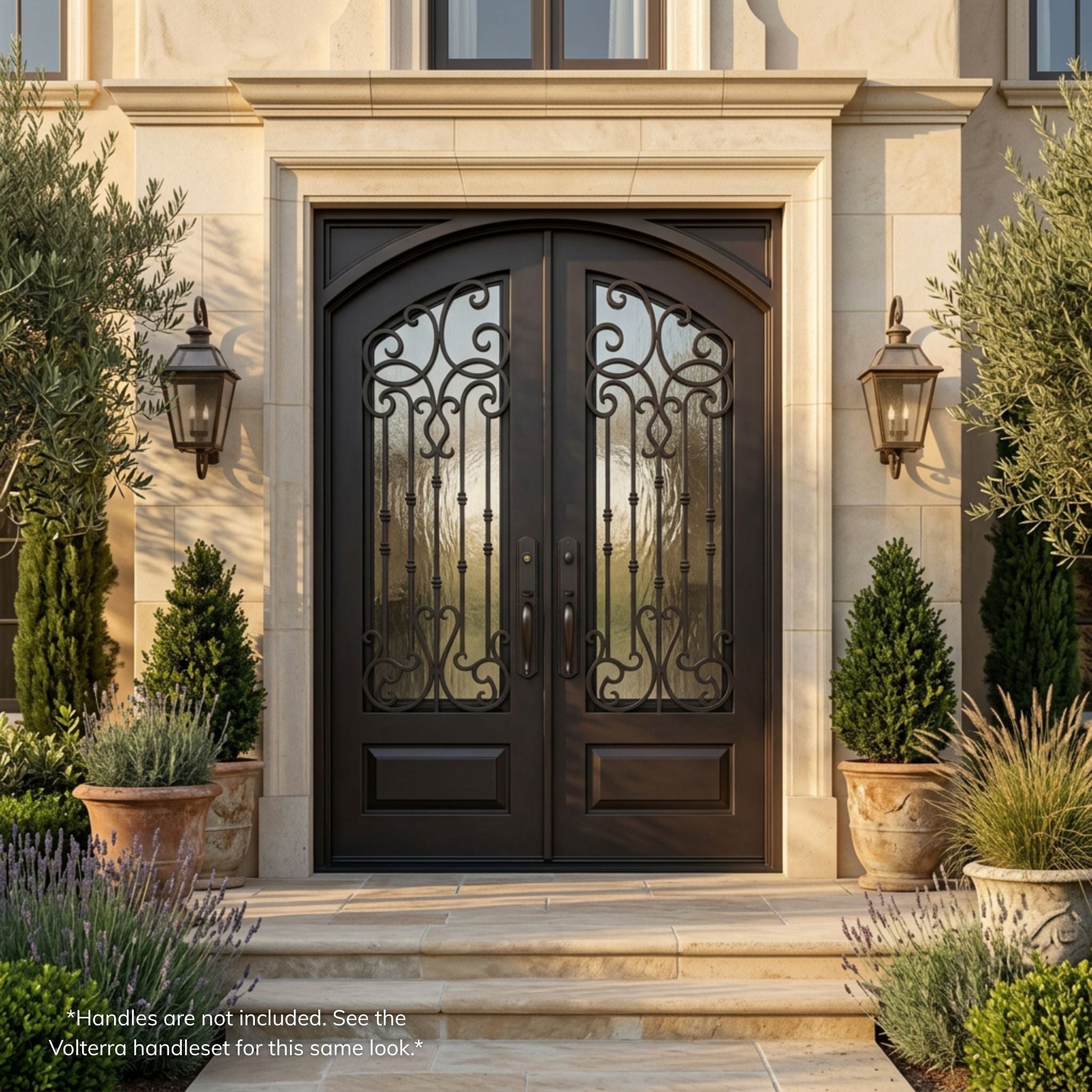 Portland double wrought iron entry door, dark oil rubbed bronze finish with scrollwork, flemish glass panels and vertical iron accents, installed on a stone Mediterranean-style home, installed view