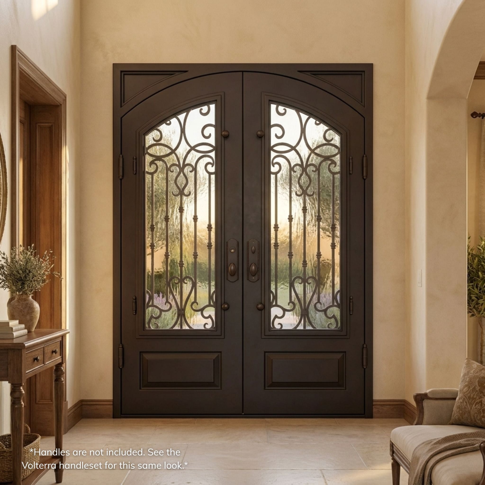 Portland double wrought iron entry door, dark oil rubbed bronze finish with scrollwork glass panels and vertical iron accents, viewed from the interior of a warm-toned Mediterranean-style foyer