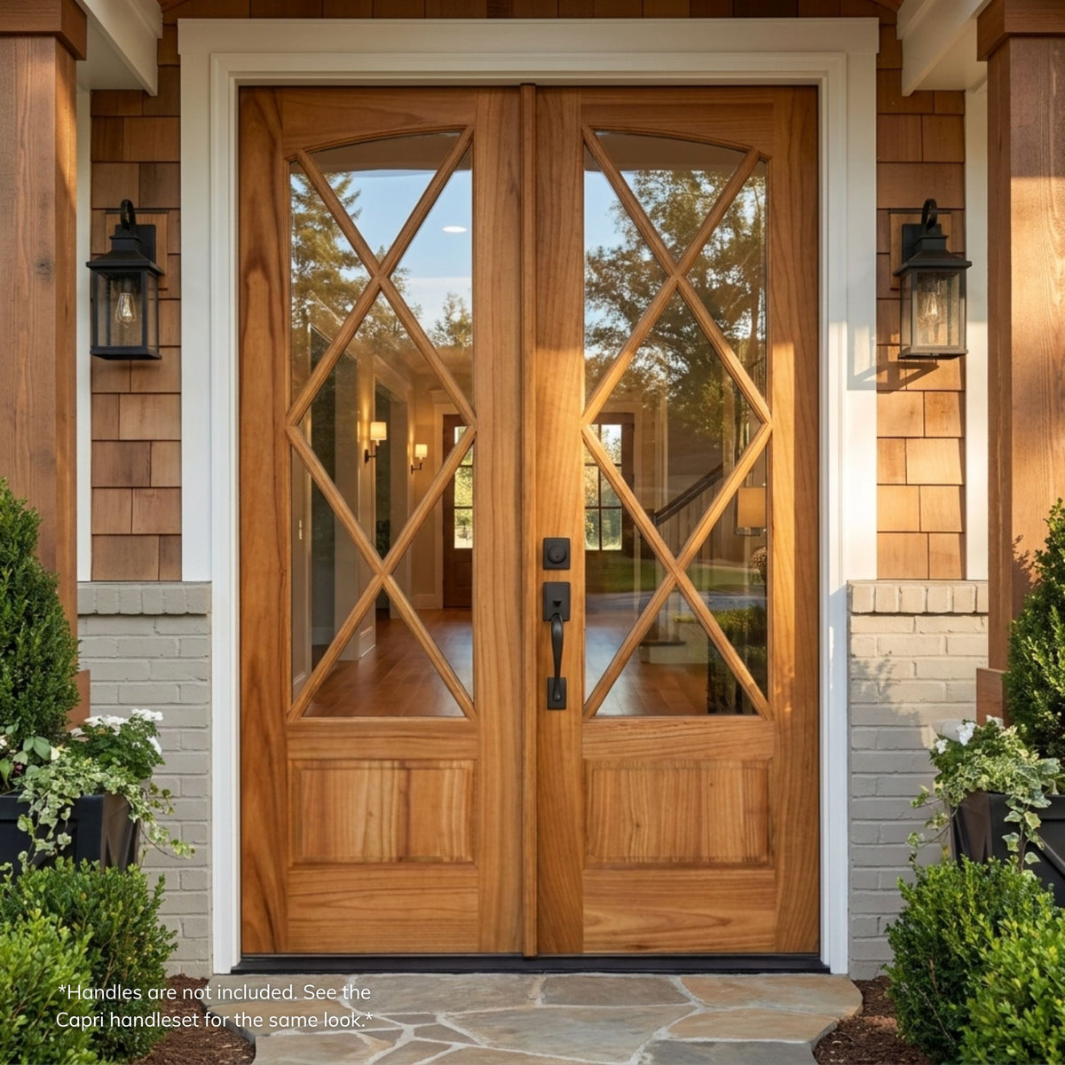 Savannah mahogany square top double door in a natural wood finish with diamond-pattern X-lite glazing, installed on a cedar-shingled home with wall lantern sconces.