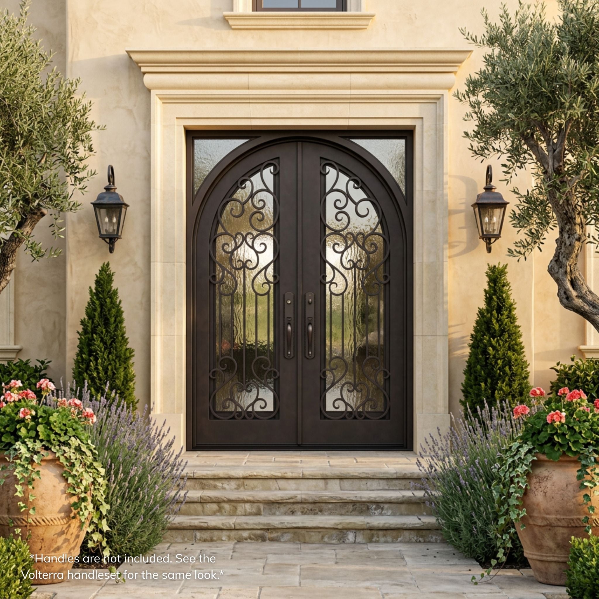 Victoria wrought iron entry double door, dark bronze finish with arch-top scrollwork glass panels, installed on a Mediterranean-style stucco home exterior 