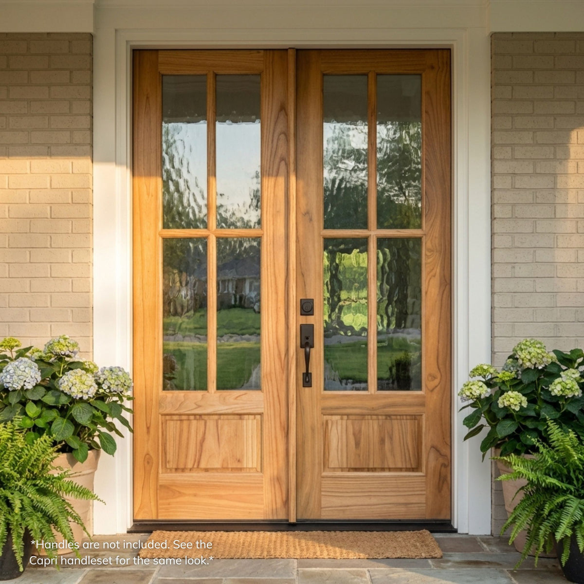 Weathercraft torrefied mahogany double entry door in a natural wood finish with 4-lite flemish textured glass on each leaf, installed on a brick home.