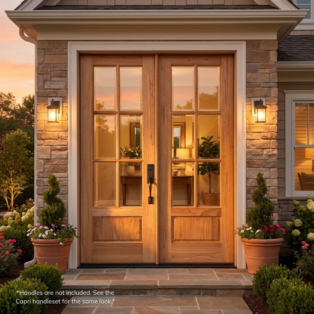 Weathercraft torrefied mahogany double entry door in a natural wood finish with 6-lite clear glass on each leaf, installed on a stone-accented home at dusk with warm interior lighting visible through the glass.