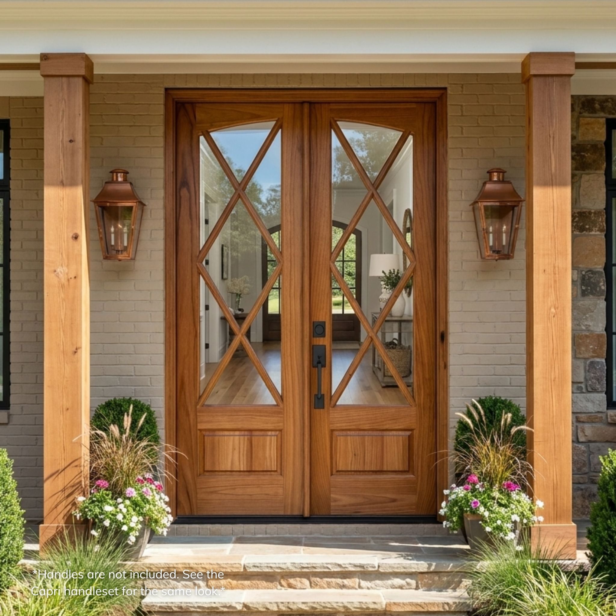 Weathercraft torrefied mahogany Tybee double entry door, wood grain finish with X-pattern muntins and clear glass, arch-top design, installed on a brick and stone craftsman home exterior